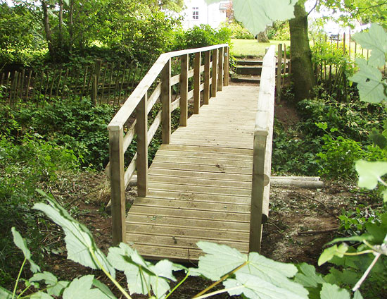 wooden bridge over stream