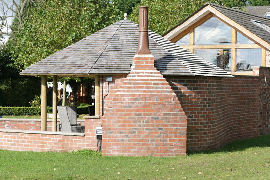 rear view of open summerhouse with chimney stack